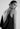 Back zoom view of a woman in a black satin sleeveless dress with back cowl drape and lace insert detail