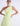 FRONT ZOOM DETAIL VIEW SUNNY LIME ONE SHOULDER PLEATED SATIN GOWN WITH HIGH-LOW HEM