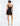 BACK VIEW BLACK SLEEVELESS A-LINE MINI DRESS WITH PLUNGING NECKLINE AND ILLUSION PANEL